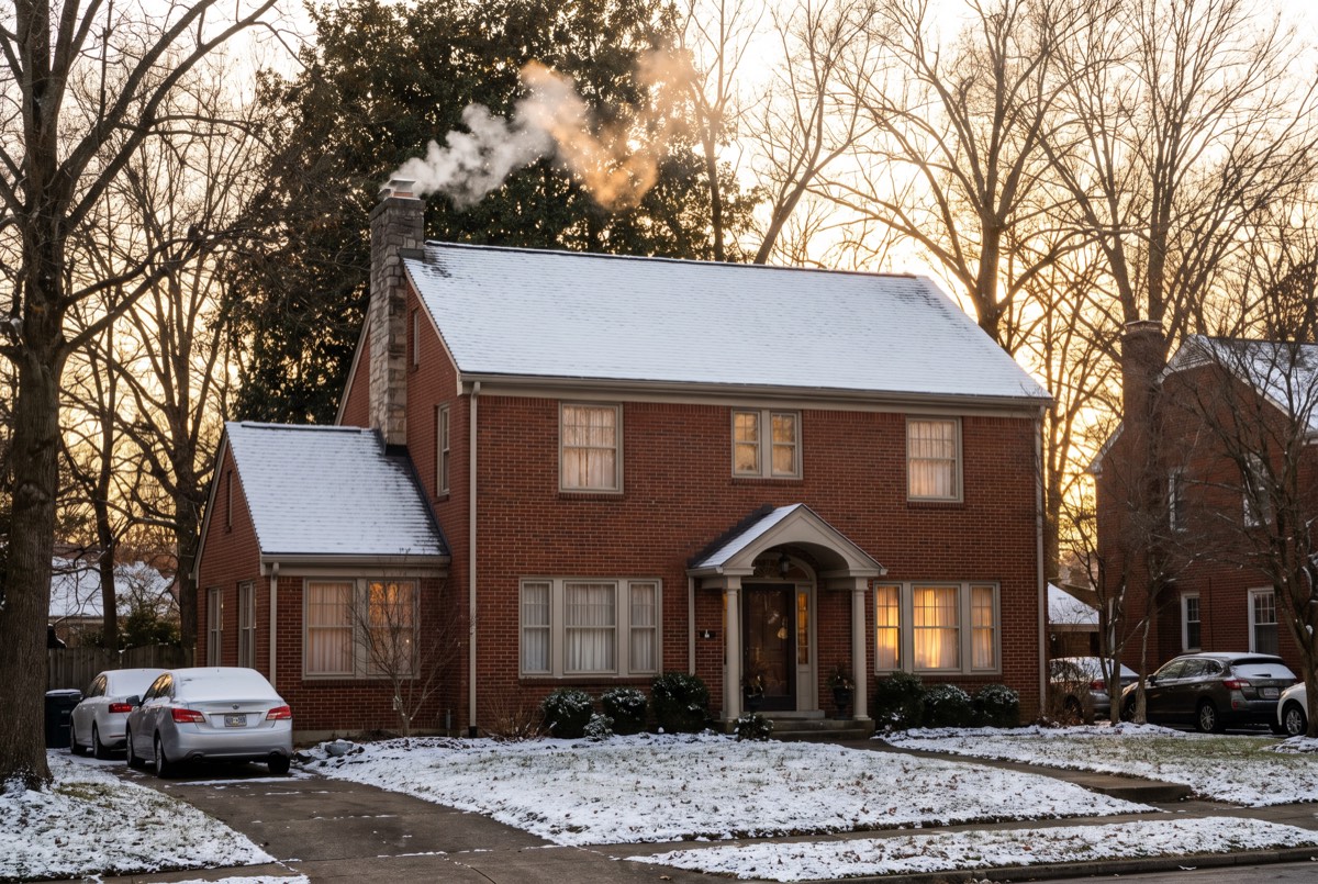 Brick Kentucky home in winter with snow and closed windows - radon testing season
